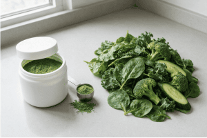green powders besides fresh leafy vegetables showing the difference between a supplement and whole foods