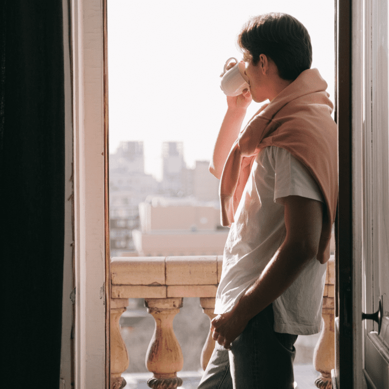 Man enjoying morning sunlight to regulate his sleep cycle and improve sleep quality.